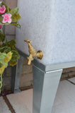 brass tap on white marble water butt